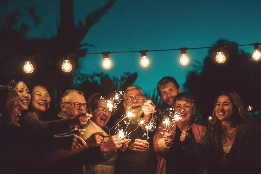 60th birthday party ideas: Woman lighting number 60 candles
