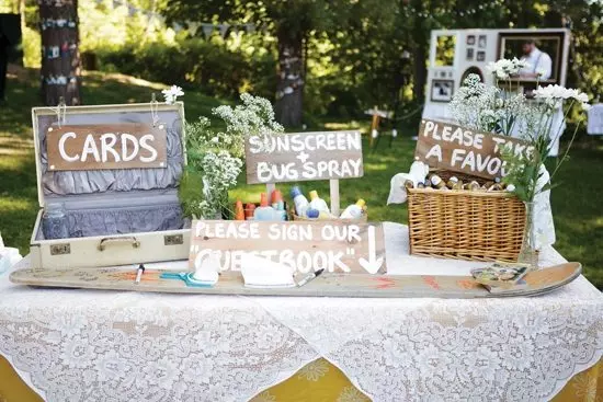 Welcome table at wedding with cards and sunscreen and favors boxes