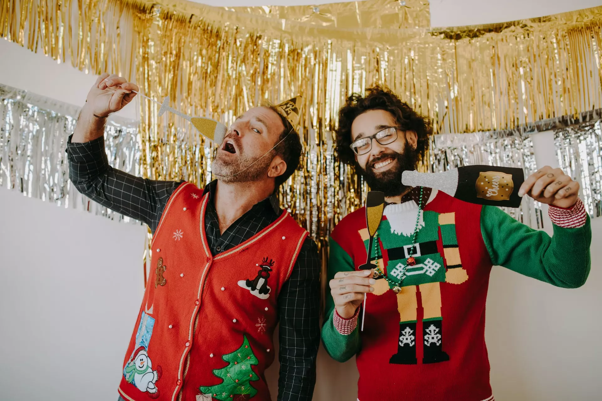 Two men posing in a Christmas-themed photo booth