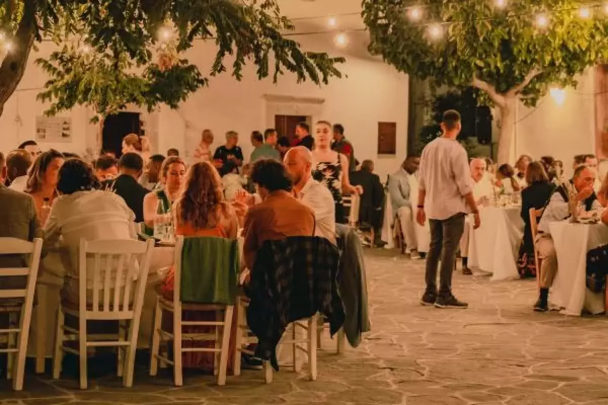 Guests sitting at tables at an outdoor event