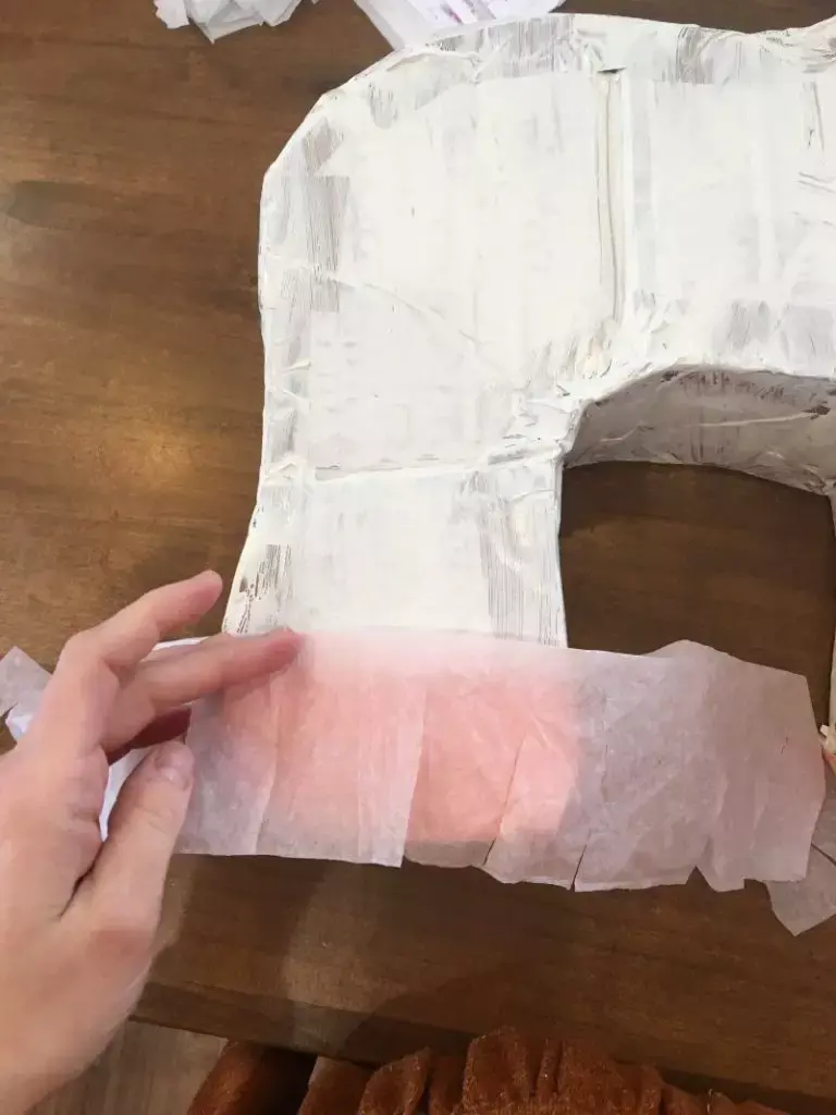 Cutting tissue paper for unicorn pinata fur