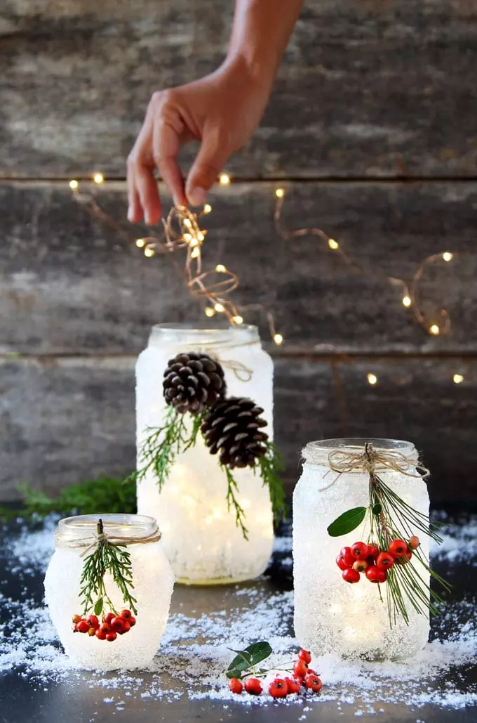 Pour salt into snowy DIY mason jar centerpieces with candles