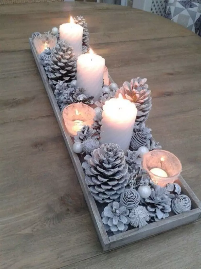 Snowy mason jar DIY Christmas centerpiece ideas with pine cones