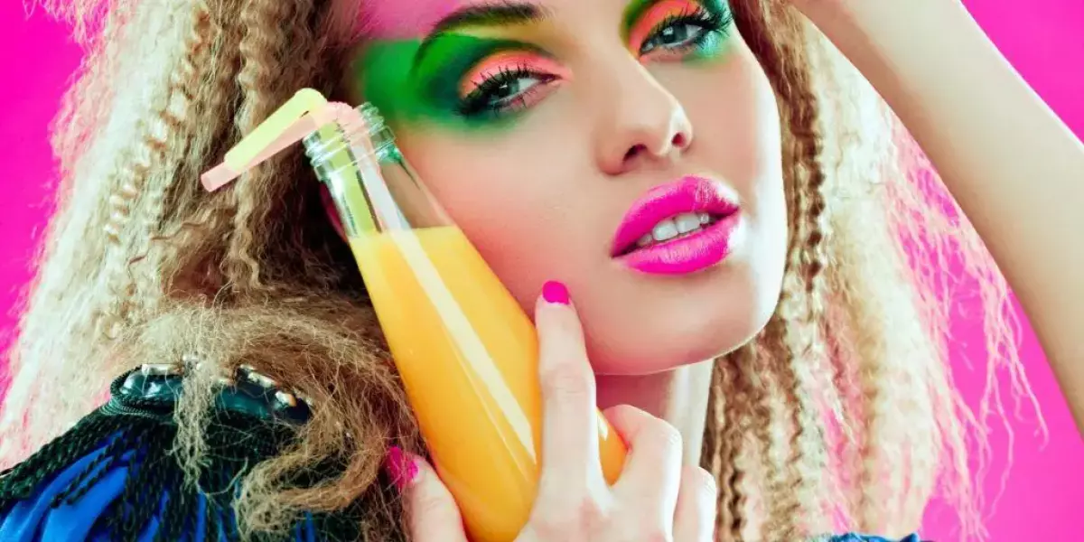 Close-up of woman wearing 80s fashion with bright neon makeup
