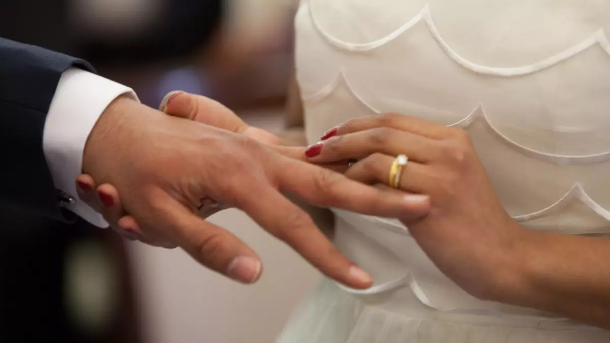 Bride Putting a Ring on Groom's Hand